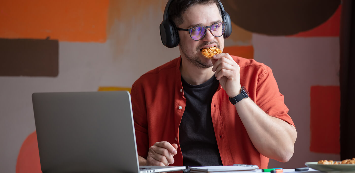 Eating a cookie at the laptop