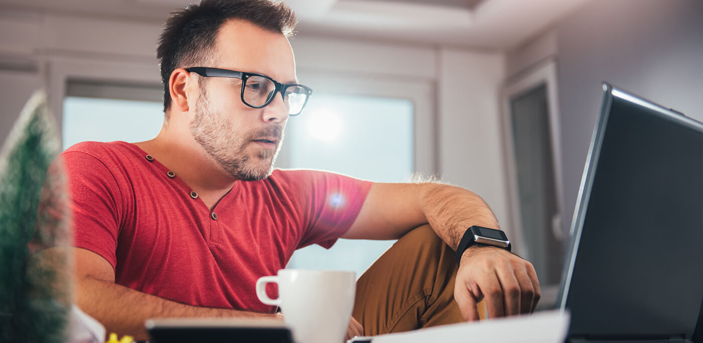 Man reading his emails on laptop