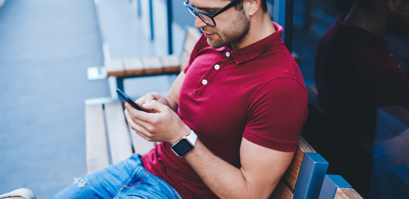 man on bench on phone