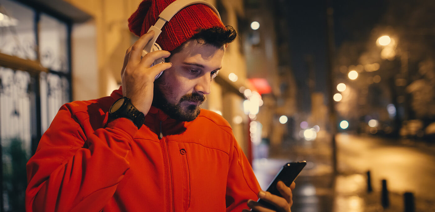 Man on headphones and mobile