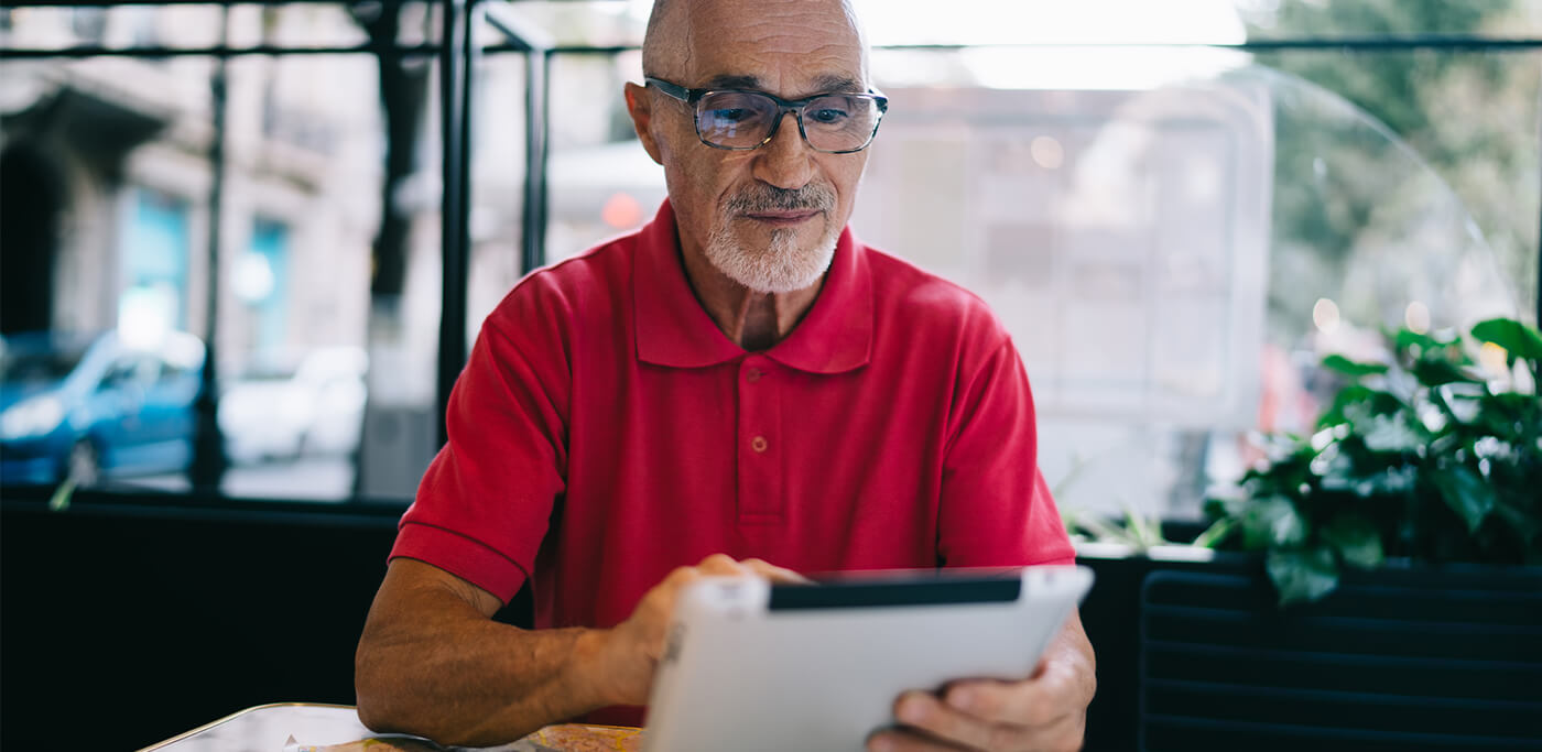 Older man checking iPad