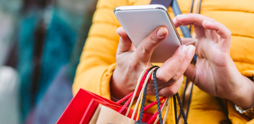 Customer checking mobile whilst shopping