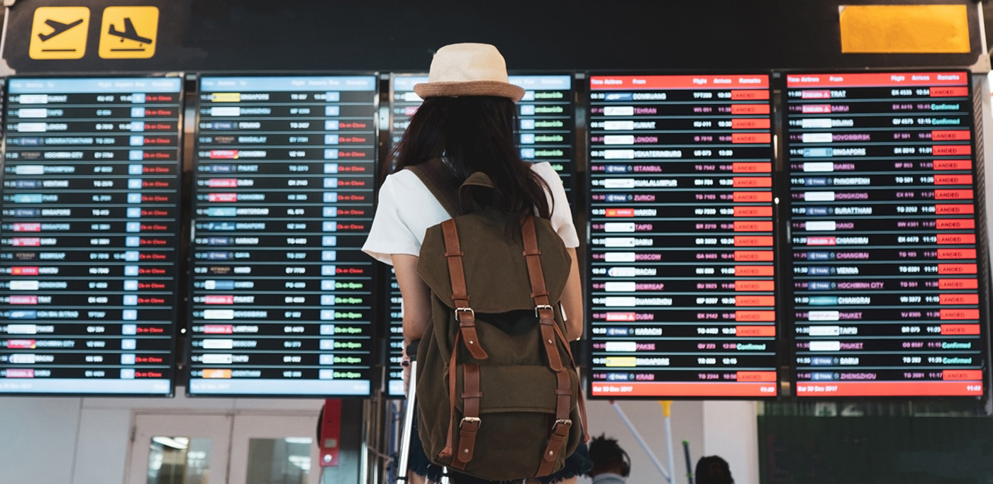 Airport traveller looking at cancelation board