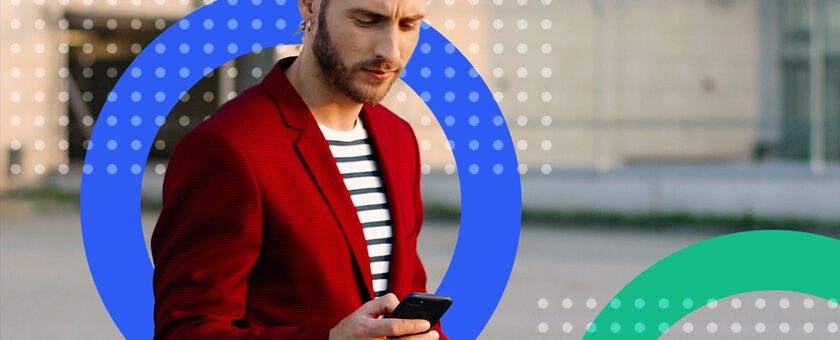 Man in red jacket reading mobile