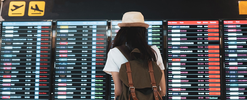Airport traveller looking at cancelation board