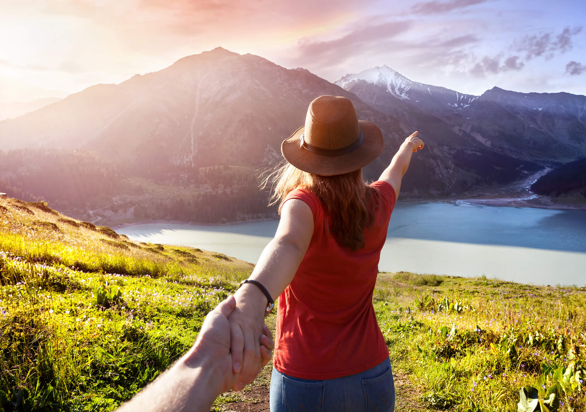 Women pointing to mountains