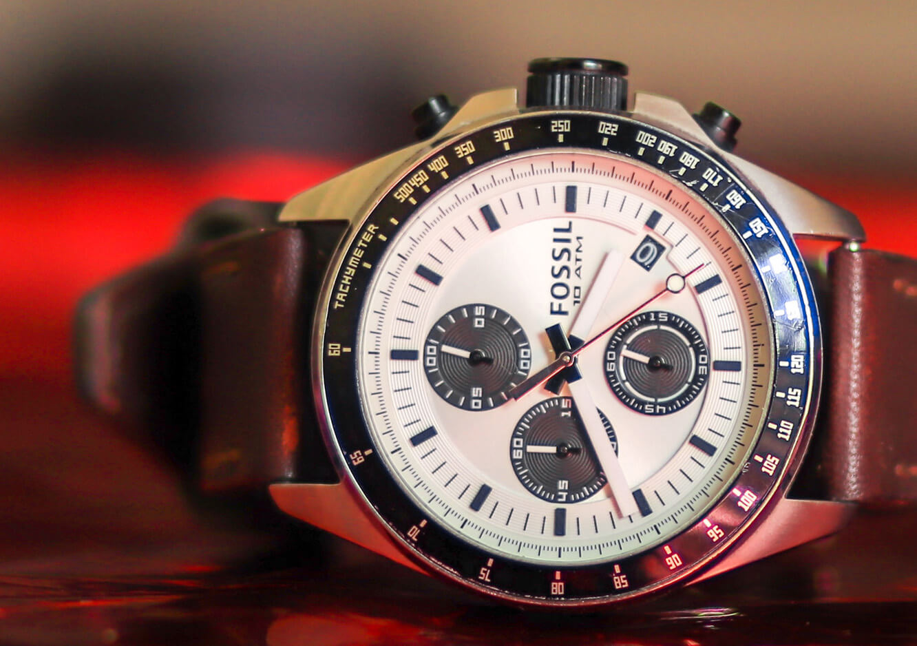 Fossil watch on red background